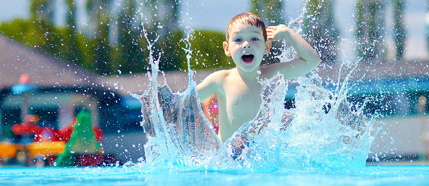child splashing around in a pool