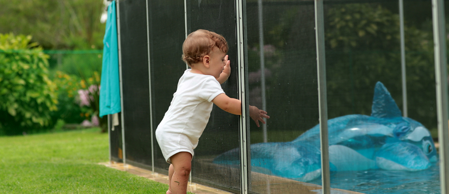 child with hand stuck in pool fence door